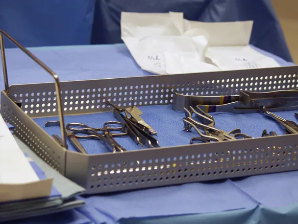Sterile instrument tray on blue surgical drape